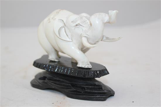 Ivory elephant on stand, a pair of bookends and two ivory bead necklaces